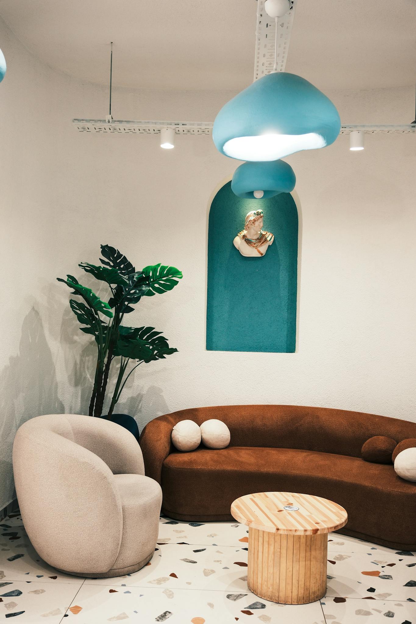 Chic modern interior featuring unique lighting, plush furniture, and vibrant decor.